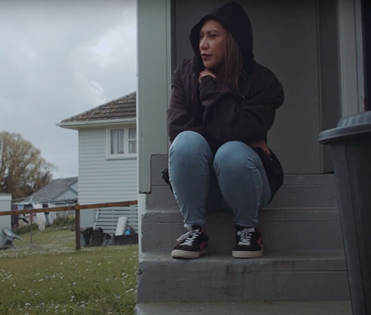 Woman sitting on steps living with debt and poverty