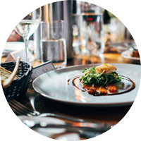 fine dining scene with elegant food on a plate with a side of bread