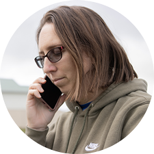 CAP Debt Help client on the phone with the CAP team who are praying for her.