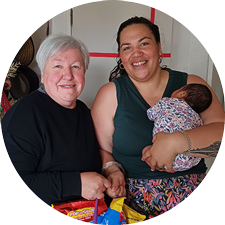Debt Help client smiling with her CAP Coach who has dropped off an emergency food parcel